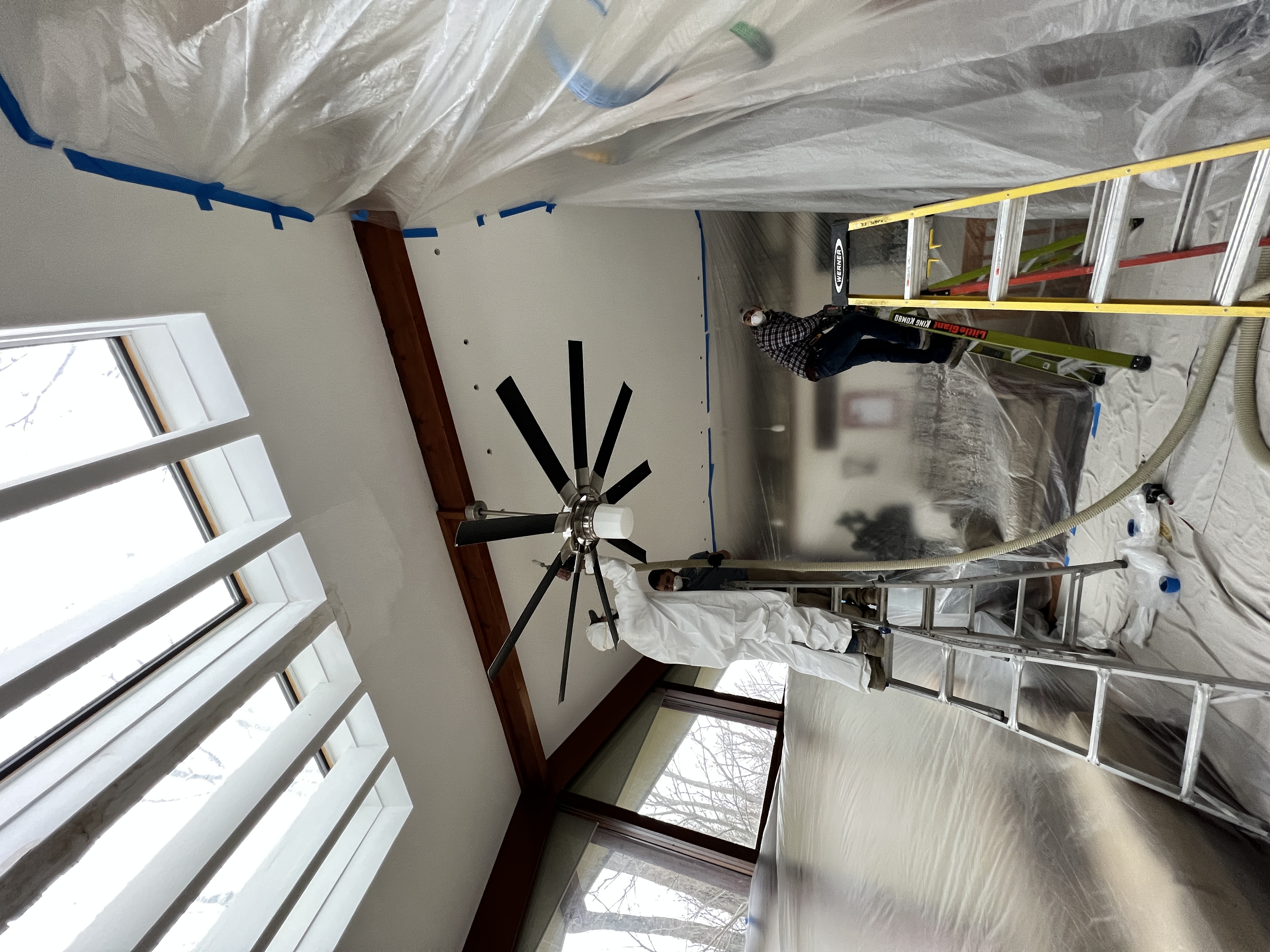 Ceiling insulation underway with the room and furnishings protected.