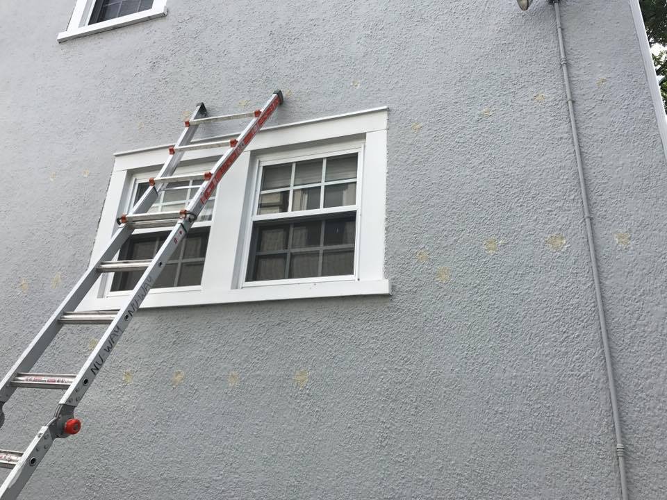 Patched openings in an existing stucco wall.