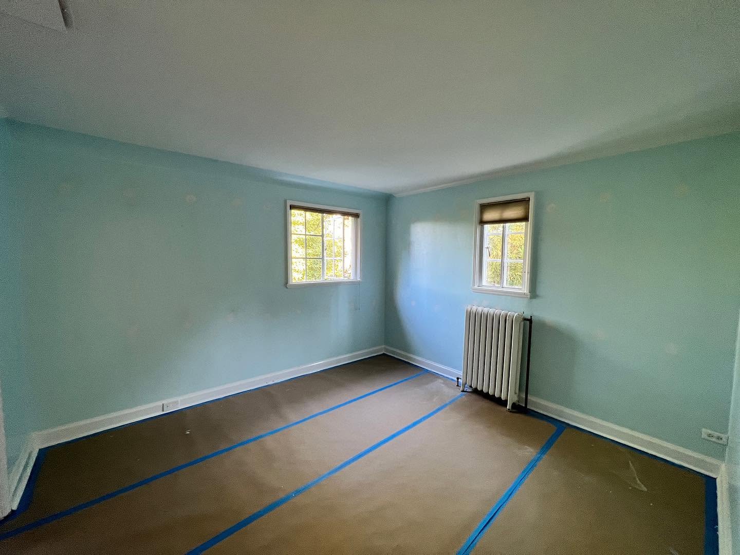 The blue room with wall access openings closed and floor protection still in place